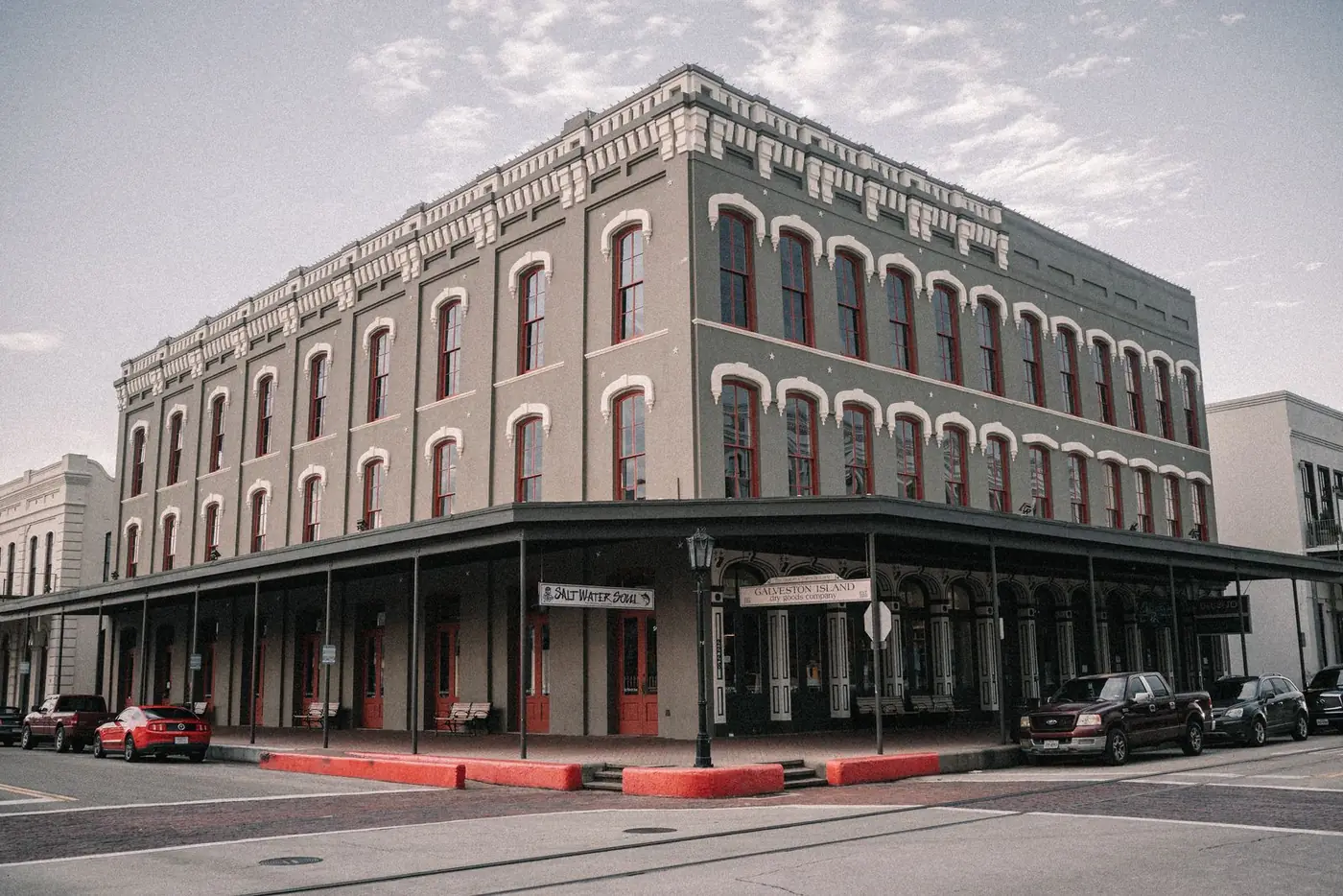 Historic three-story commercial building with a covered sidewalk arcade in the Strand district of Galveston, Texas